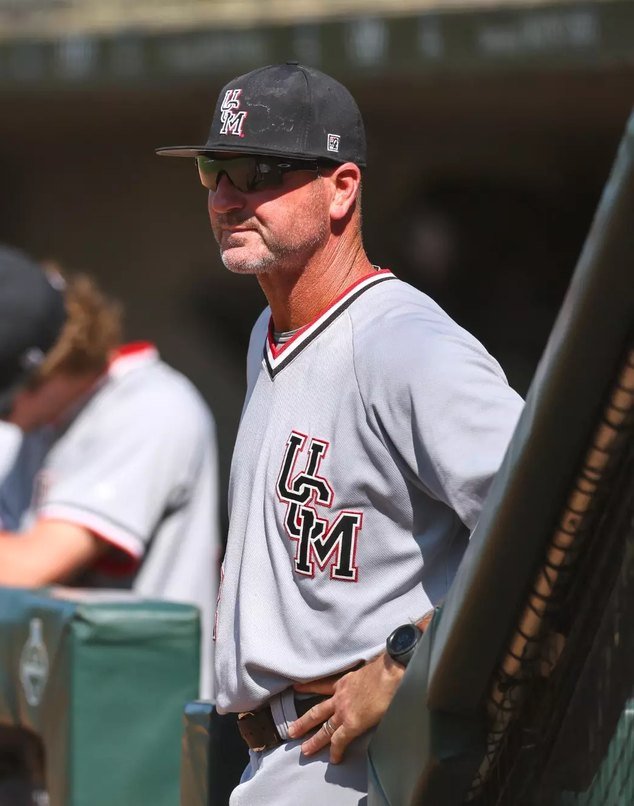 Head coach Kyle Crookes watching from the dugout