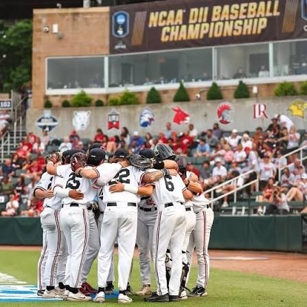 Mules huddle under the championship scoreboard