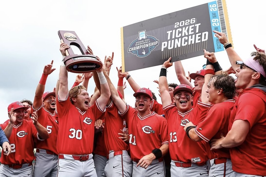 2026 Mules raising the trophy and the Ticket Punched sign